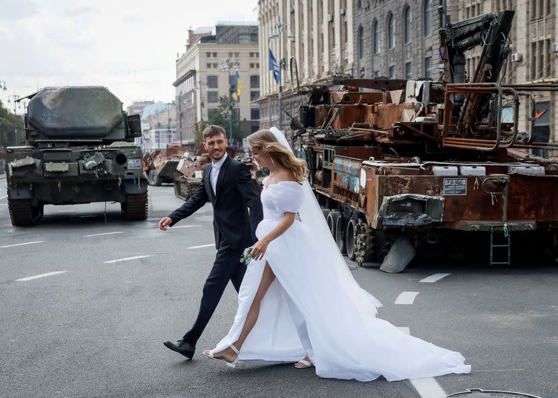 Newlyweds visit an exhibition displaying destroyed Russian military vehicles in central Kyiv
