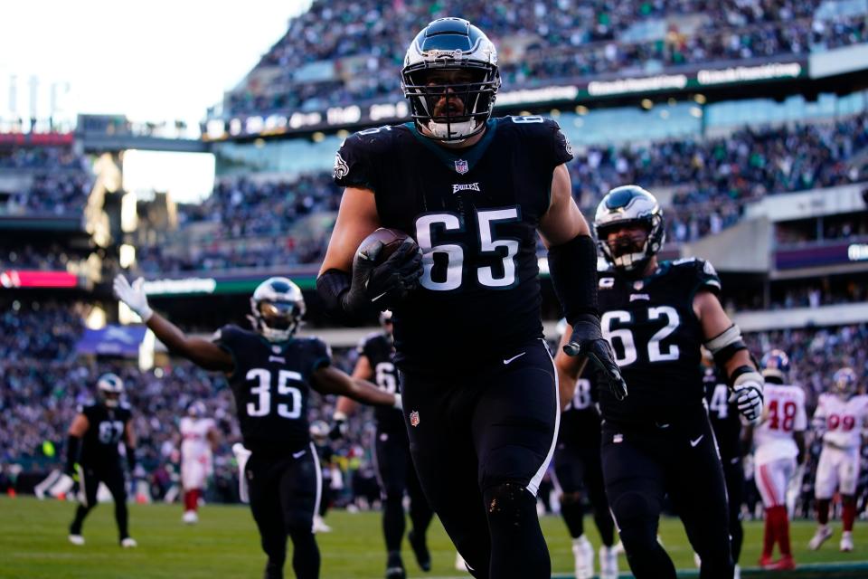 Philadelphia Eagles' Lane Johnson scores a touchdown during the second half of an NFL football game against the New York Giants, Sunday, Dec. 26, 2021, in Philadelphia. (AP Photo/Matt Rourke)