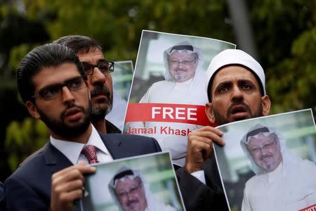 FILE PHOTO: Human rights activists and friends of Saudi journalist Jamal Khashoggi hold his pictures during a protest outside the Saudi Consulate in Istanbul, Turkey October 8, 2018. REUTERS/Murad Sezer/File Photo