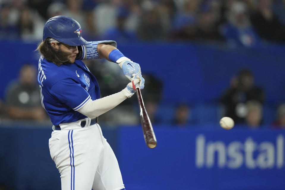 Toronto Blue Jays shortstop Bo Bichette (11) hits a single during the fourth inning of a baseball game against the New York Yankees in Toronto on Monday, Sept. 26, 2022. (Nathan Denette/The Canadian Press via AP)