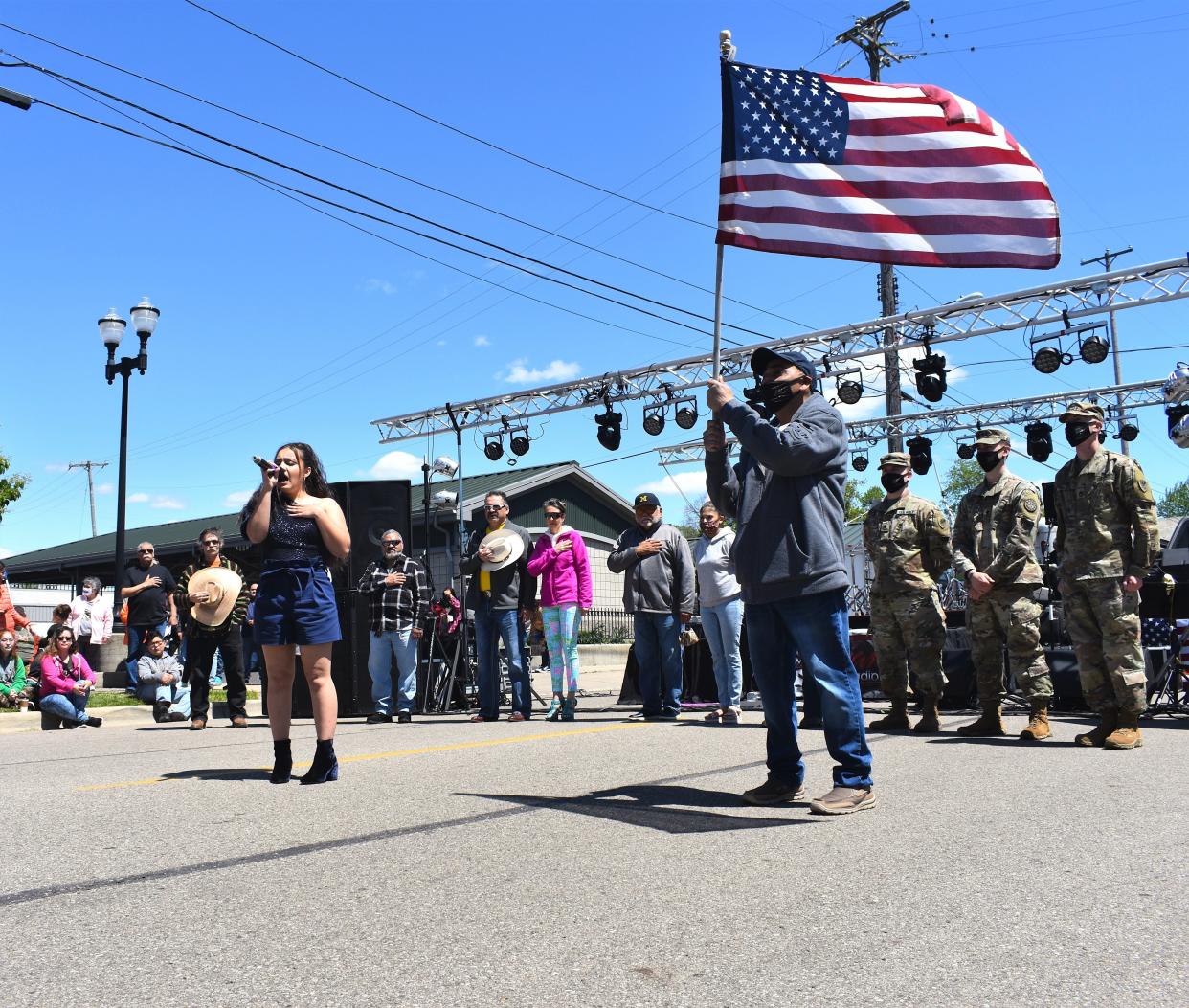 Adrian teen Rio Doyle, left, sings the national anthem during Adrian's Cinco de Mayo Parade and Festival in 2021. Standing next to Doyle and holding the American flag is longtime Cinco de Mayo Parade and Festival co-organizer Chico Martinez. Cinco de Mayo will be celebrated in Adrian again this year on Saturday, May 6. It has been renamed Chico's Annual Cinco de Mayo Parade and Festival in memory of Martinez who died Nov. 8, 2022.