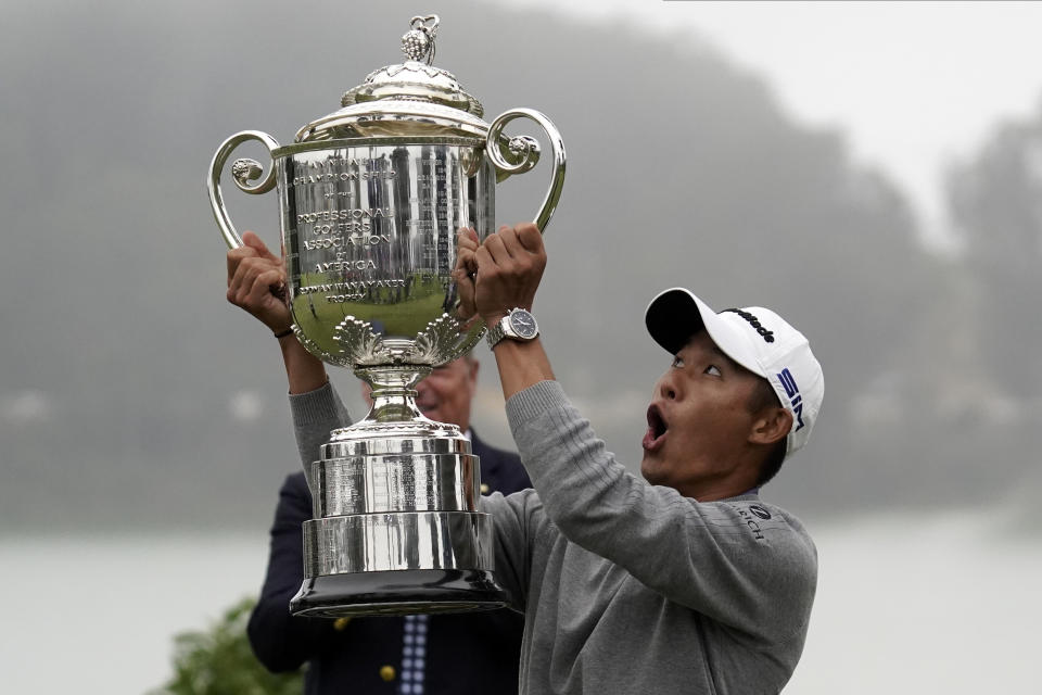 Collin Morikawa reacts as the top of the Wanamaker Trophy falls after winning the PGA Championship. (AP Photo/Jeff Chiu)