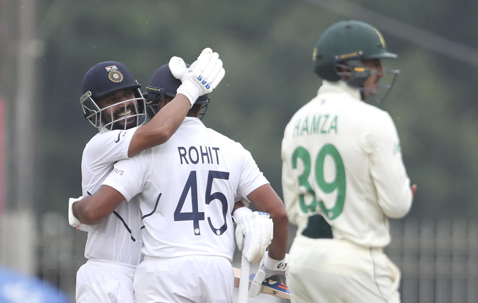 India's Ajinkya Rahane, left, hugs teammate Rohit Sharma to congratulate on scoring a century during first day of the third and last cricket test match between India and South Africa in Ranchi, India, Saturday, Oct. 19, 2019. (AP Photo/Aijaz Rahi)