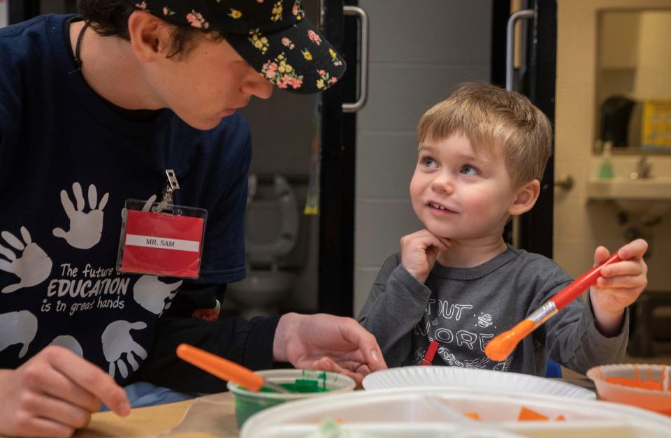 Sam Gamet, a senior at Canton High School, helps a preschool student with their work during a Kiddie Campus class in Canton on Oct. 26, 2023. The Kiddie Campus class is one of the specialized classes offered at the Plymouth-Canton Educational Park that is geared toward students who might find a career related to early childhood education or teaching.