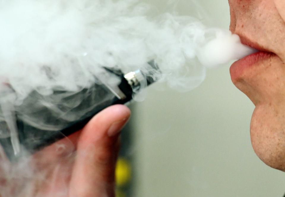 A man exhaling whilst using a vaping product (Nick Ansell/PA) (PA Archive)