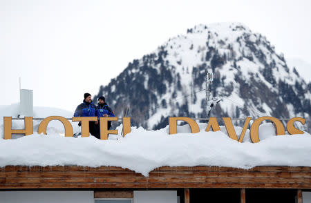 Policemen keep watch from a rooftop ahead of inauguration of World Economic Forum (WEF) in Davos, Switzerland, January 21, 2019. REUTERS/Arnd Wiegmann