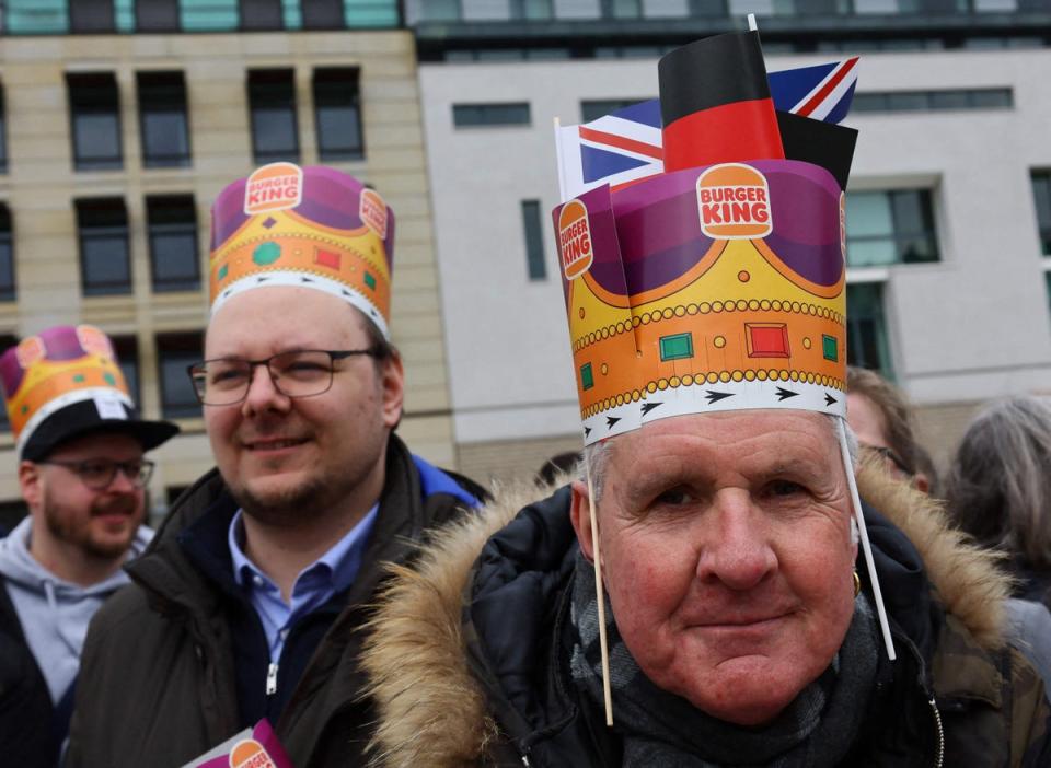 Well-wishers wearing Burger King crowns at Brandenburg Gate (POOL/AFP via Getty Images)