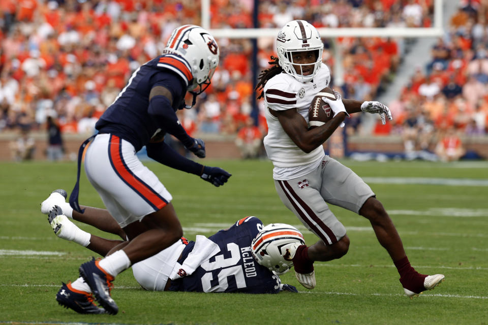 Mississippi State wide receiver Zavion Thomas (1) catches a pass as Auburn linebacker Jalen McLeod (35) and cornerback Keionte Scott (0) defend during the first half an NCAA college football game against Mississippi State, Saturday, Oct. 28, 2023, in Auburn, Ala. (AP Photo/Butch Dill)