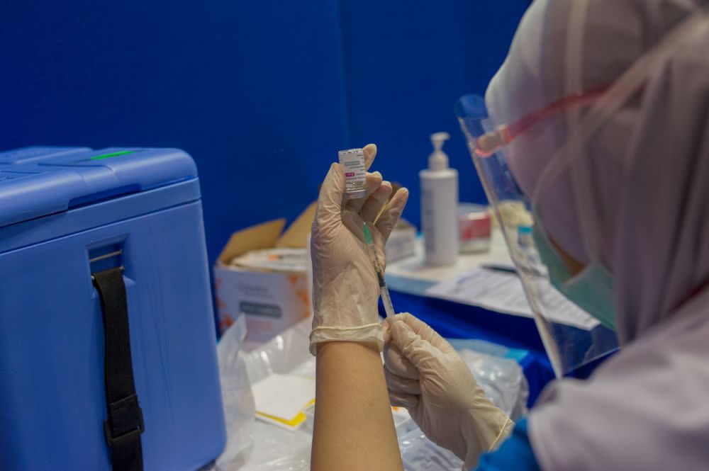 A nurse loads a syringe with a dose of the AstraZeneca Covid-19 vaccine at the Dewan Gemilang UKM vaccination centre in Bangi May 5, 2021. — Picture by Shafwan Zaidon