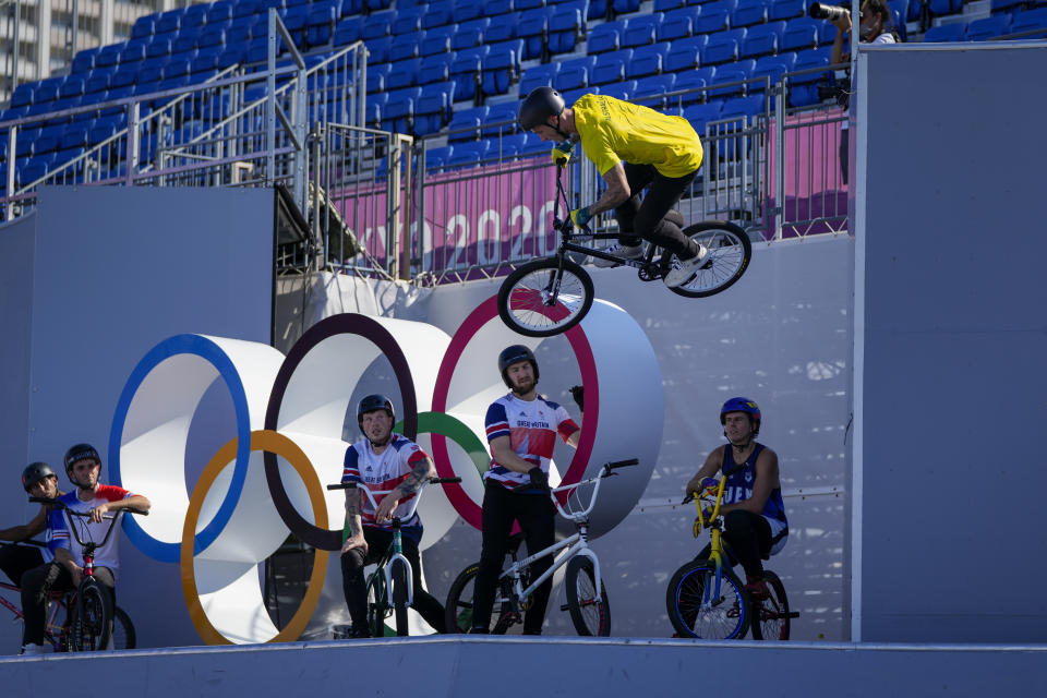 Logan Martin of Australia makes a jump as other competitors watch during a BMX Freestyle training session at the 2020 Summer Olympics, Tuesday, July 27, 2021, in Tokyo, Japan. (AP Photo/Ben Curtis)