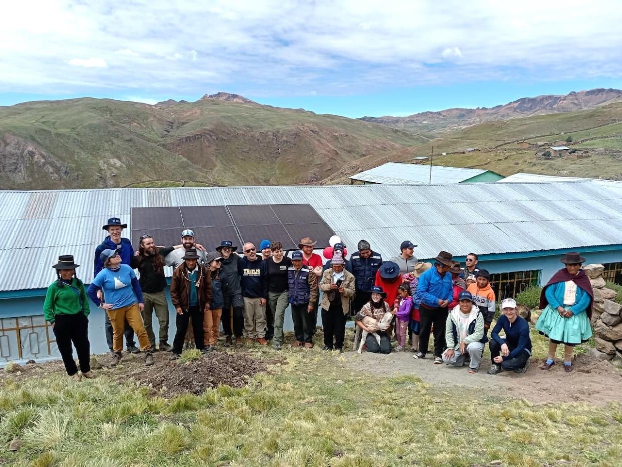 The group in Peru, in front of one of the buildings they installed the solar project on. (Submitted by Isabelle Thériault - image credit)