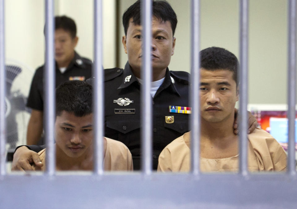 Myanmar migrants Win Zaw Htun, right, and Zaw Lin, left, both 22, are escorted by officials after their guilty verdict at court in Koh Samui, Thailand, Thursday, Dec. 24, 2015. A Thai court on Thursday sentenced the two Myanmar migrants to death for killing British backpackers David Miller, 24, and Hannah Witheridge, 23,  on the resort island of Koh Tao last year, a crime that focused global attention on tourist safety and police conduct in the country. (AP Photo/Wason Wanichakorn)