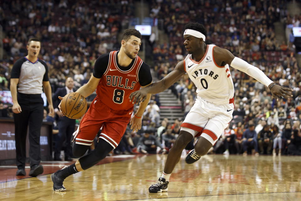 Chicago Bulls guard Zach LaVine (8) drives against Toronto Raptors guard Terence Davis (0) during the first half of their NBA basketball game in Toronto, Sunday, Oct. 13, 2019. (Cole Burston/The Canadian Press via AP)