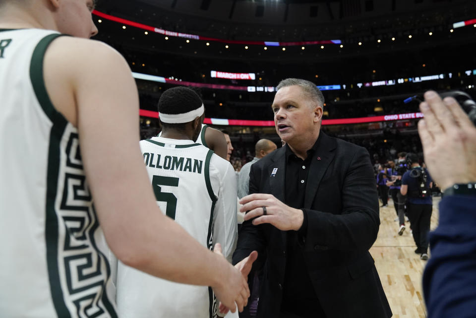 Ohio State's head coach Chris Holtmann shake hands with Michigan State players after an NCAA college basketball game at the Big Ten men's tournament, Friday, March 10, 2023, in Chicago. Ohio State won 68-58. (AP Photo/Erin Hooley)