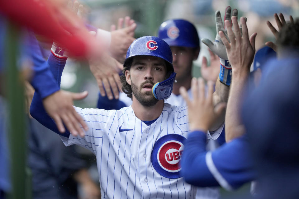 Chicago Cubs' Dansby Swanson celebrates in the dugout after hitting a two-run home run off Atlanta Braves starting pitcher Bryce Elder during the first inning of a baseball game Saturday, Aug. 5, 2023, in Chicago. (AP Photo/Charles Rex Arbogast)