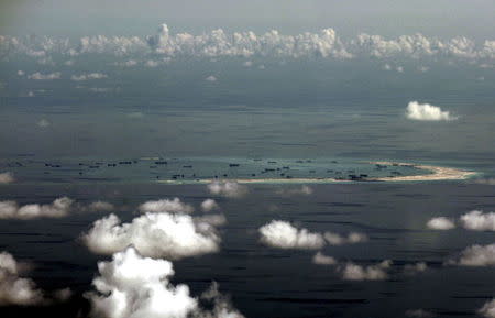 The alleged ongoing land reclamation by China on Mischief Reef in the Spratly Islands in the South China Sea, west of Palawan, Philippines, is seen in this aerial file photo taken though a glass window of a Philippine military plane on May 11, 2015. REUTERS/Ritchie B. Tongo/Pool/Files