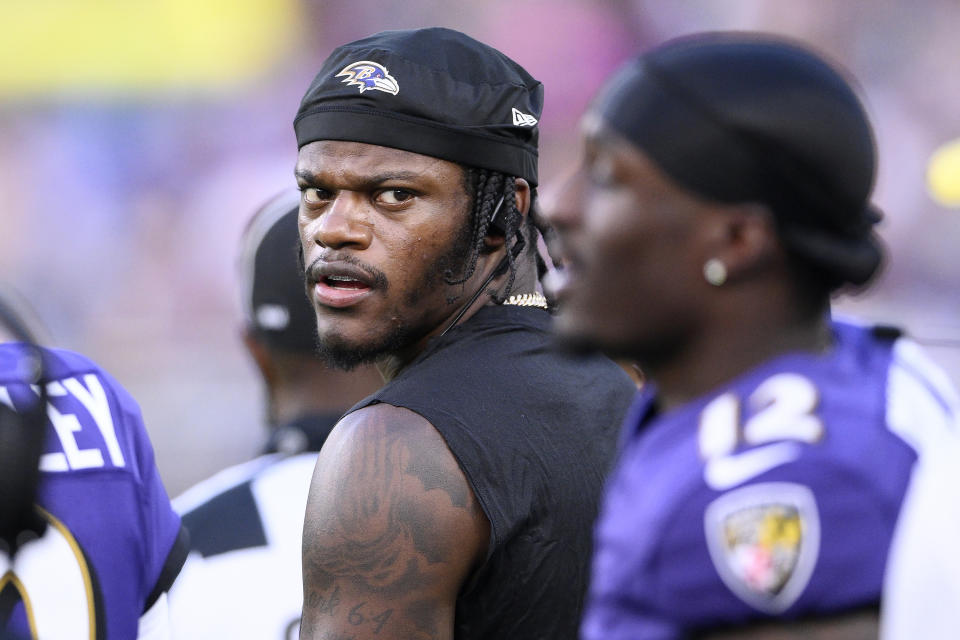 Baltimore Ravens quarterback Lamar Jackson, middle, stands on the sideline during the second half of an NFL preseason football game against the Philadelphia Eagles in Baltimore, Saturday, Aug. 12, 2023. (AP Photo/Nick Wass)