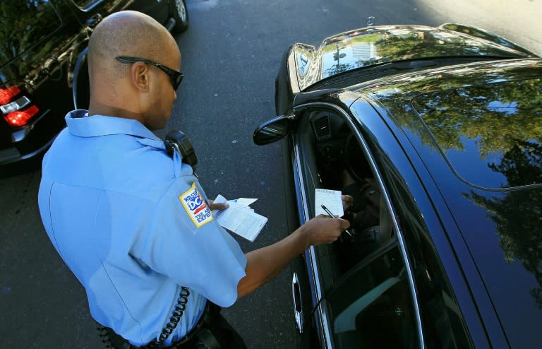 Metropolitan Police Officer Tyrone Gross, hands out a warning to a motorist who was talking on his cell phone on September 21, 2010 in Washington, DC