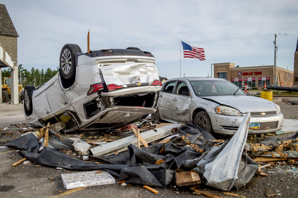 Two heavily-damaged vehicles rest in the Hobby Lobby parking lot amid the damage and aftermath from a tornado the day before along Michigan state Highway 32, Saturday, May 21, 2022, in Gaylord, Mich. (Jake May/MLive.com/The Flint Journal via AP)