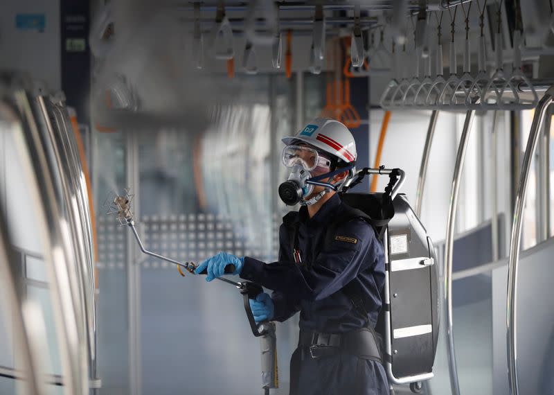 An employee of the Tokyo Metro sprays chemicals for anti-virus and bacteria coating in order to prevent infections following the coronavirus disease (COVID-19) outbreak in Tokyo