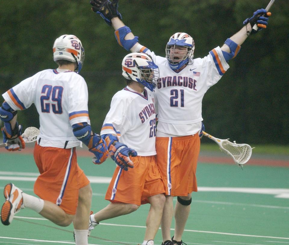 Syracuse midfielder Sean Lindsay (21) raises his arms in victory after scoring the winning goal to defeat Georgetown, 8-7, with seconds left in regulation in the NCAA Division I lacrosse championship quarterfinals in Ithaca, N.Y., Sunday, May 23, 2004. The former Lakeland/Panas All-American is part of the Hudson Valley Lacrosse Hall of Fame's 2023 class.