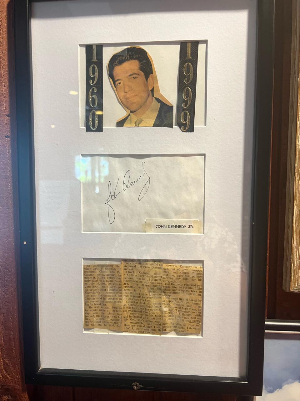 A photo of John F. Kennedy Jr. and his autograph hangs on the walls inside C.J. Cannons restaurant in Vero Beach.