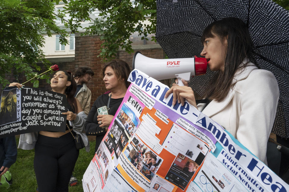 Christina Taft demonstrates in support of Amber Heard as supporters of actor Johnny Depp rally outside of Fairfax County Courthouse in Fairfax, Va., on Friday, May 27, 2022. A jury is scheduled to hear closing arguments in Johnny Depp's high-profile libel lawsuit against ex-wife Amber Heard.(AP Photo/Craig Hudson)