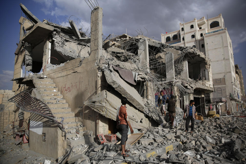 FILE - In this Monday, Jan. 25, 2016 photo, men inspect a house destroyed by a Saudi-led airstrike in Sanaa, Yemen. The missile fired by the Saudi-led coalition killed a judge and his entire family in the Nahda neighborhood, security officials said. The judge was a known Houthi supporter. On Wednesday, April 8, 2020, the Saudi-led coalition fighting the Iranian-backed Houthi rebels in Yemen announced that its forces would begin a cease-fire starting at midnight, in what could pave the way for the first direct peace talks between the two sides that have been at war for more than five years. (AP Photo/Hani Mohammed)