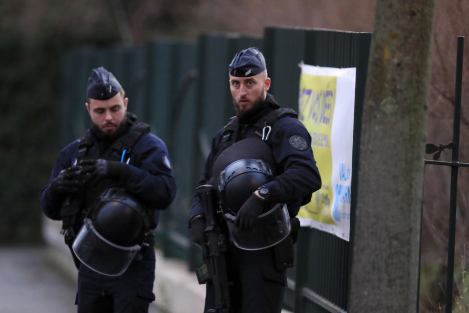 Riot police officers look on after a man attacked passerby Friday Jan.3, 2020 in Villejuif, south of Paris. A man armed with a knife rampaged through a Paris park attacking passers-by seemingly at random Friday, killing at least one person and injuring two others before police shot him dead, officials said. (AP Photo/Michel Euler)