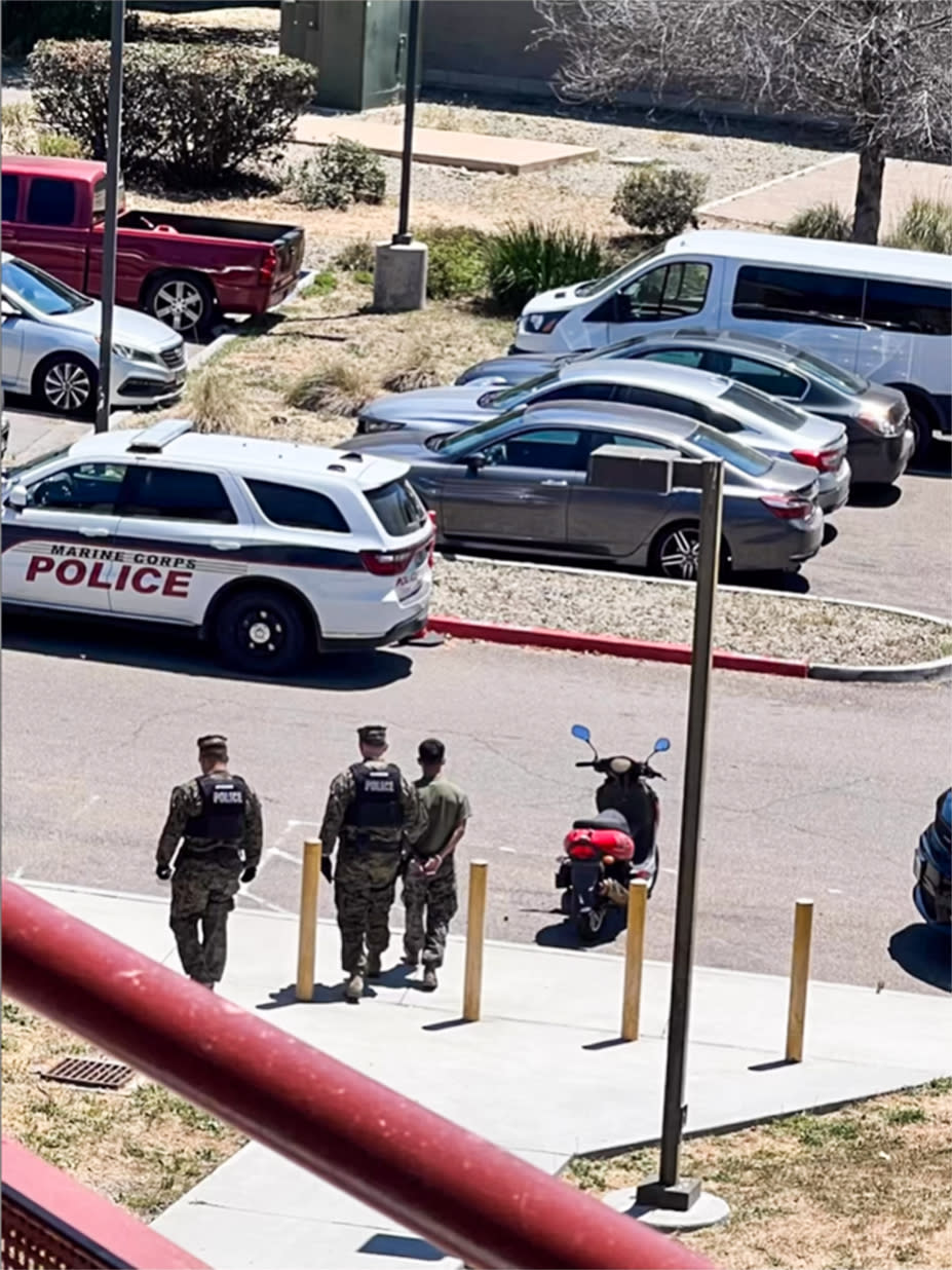 Police take a Marine into custody on June 28, 2023, at Camp Pendleton in Oceanside, Calif., in connection with a teen who was missing for 15 days. (@notinregz via Instagram)