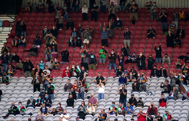 Harlequins fans celebrate a try, but their team were beaten