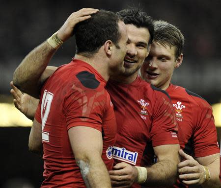 Wales' Mike Phillips (C) congratulates Jamie Roberts (L) on scoring a try against Scotland during their Six Nations Championship rugby union match at the Millennium Stadium, Cardiff, Wales, March 15, 2014. REUTERS/Rebecca Naden