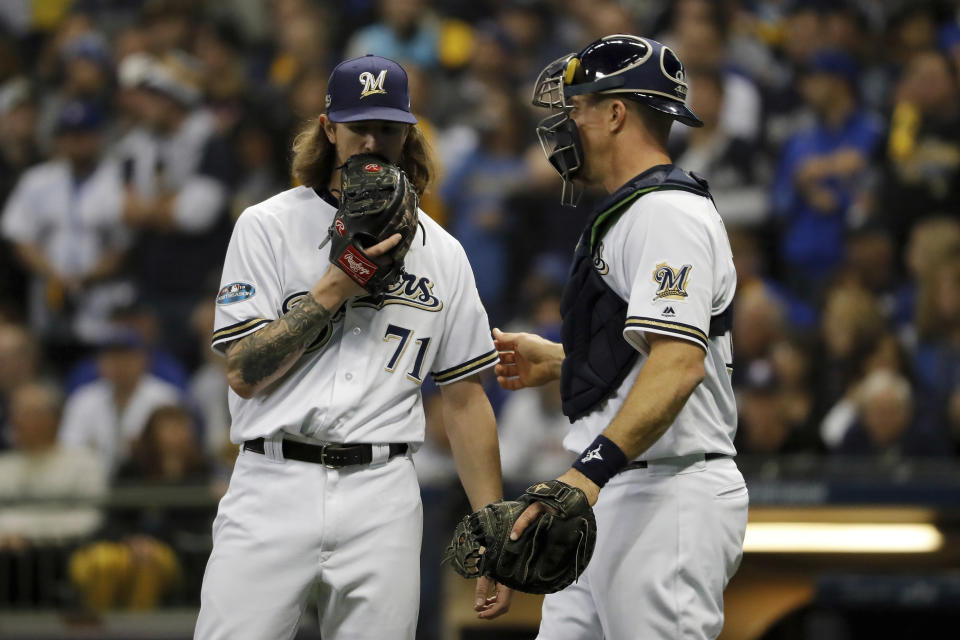 Milwaukee Brewers relief pitcher Josh Hader (71) and catcher Erik Kratz talks on the mound during the fifth inning of Game 7 of the National League Championship Series baseball game against the Los Angeles Dodgers Saturday, Oct. 20, 2018, in Milwaukee. (AP Photo/Jeff Roberson)