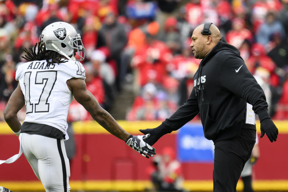 Las Vegas Raiders interim head coach Antonio Pierce congratulates Raiders wide receiver Davante Adams as he comes off the field during the first half of an NFL football game against the Kansas City Chiefs, Monday, Dec. 25, 2023 in Kansas City, Mo. (AP Photo/Reed Hoffmann)