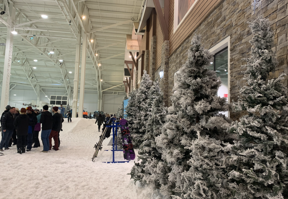 To make Big SNOW look less like a stark warehouse and more like a mountain resort, designers were inspired to replicate a ski chalet and pine trees were added to enhance the landscape. (Photo credit: Kristen Despotakis/Yahoo Finance)