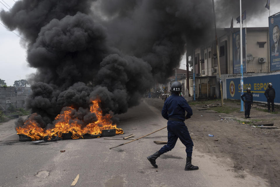 Security forces clash with supporters of presidential candidate Martin Fayulu outside his party's headquarters, in Kinshasa, Democratic Republic of the Congo, Wednesday, Dec. 27, 2023. Fayulu, a main opposition candidate accused police of using live bullets to break up a protest Wednesday in Congo's capital, as demonstrators demanded a re-do for last week's presidential election. Fayulu is one of five opposition candidates who say the election should be rerun and question its credibility. Some rights groups and international observers also have questioned the vote. (AP Photo/Mosa'ab Elshamy)