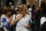 Angelica Macias Diaz, second left, who lost her son Raul Alexis Vargas, 7, is comforted by other relatives of the students and faculty who were killed when a building collapsed at the Enrique Rebsamen school during the 2017 earthquake embrace following a Catholic Mass next to the remains of the school, in southern Mexico City, Thursday, Sept. 19, 2019. Mexico was marking Thursday the Sept. 19 anniversaries of the 2017 earthquake that killed more than 300 people and a devastating 1985 temblor that left at least 9,500 dead.(AP Photo/Rebecca Blackwell)