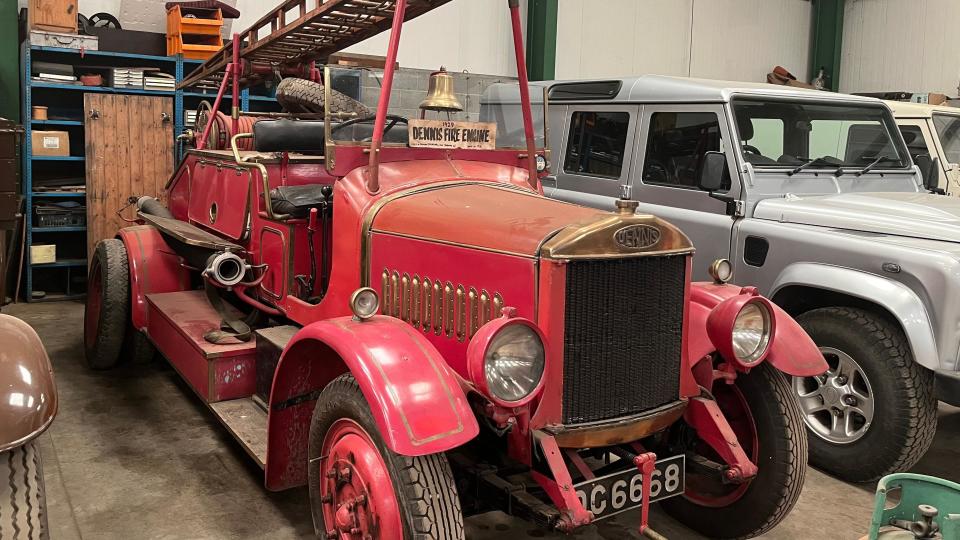 A vintage red fire engine with ladder and hand-rung bell 