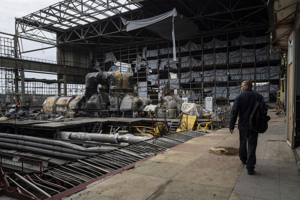 A worker walks inside a power plant that was destroyed by a Russian rocket attack on March 22, in Kharkiv, Ukraine, on Wednesday, April 17, 2024. (AP Photo/Evgeniy Maloletka)