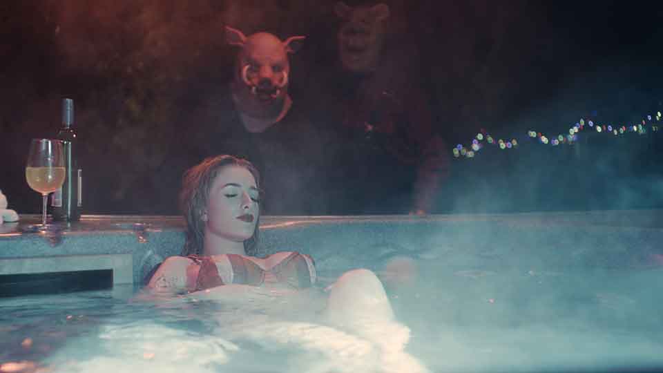 Lara (Natasha Tosini) has a night in the hot tub interrupted by Piglet and Pooh in "Winnie-the-Pooh: Blood and Honey."