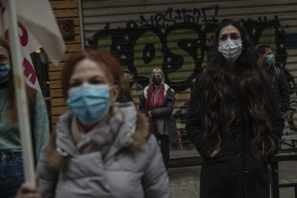 Primary school teachers wearing face masks protest outside Health Ministry demanding more safety measures in schools against the coronavirus pandemic, in Athens, Friday, Jan. 15, 2021. Primary schools and kindergartens reopened this week, but high school lessons are being held online only.Greece's prime minister says the country's retail sector might begin to gradually reopen next week, if the scientists advising the government on the coronavirus pandemic recommend it is safe to do so today. (AP Photo/Petros Giannakouris)