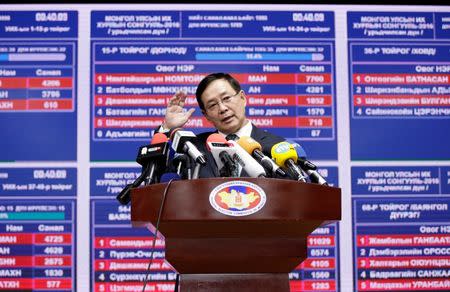 An official from the General Election Commission of Mongolia speaks at a news conference, in front of an electronic board showing the results of parliamentary elections, in Ulaanbaatar, Mongolia June 29, 2016. REUTERS/Jason Lee