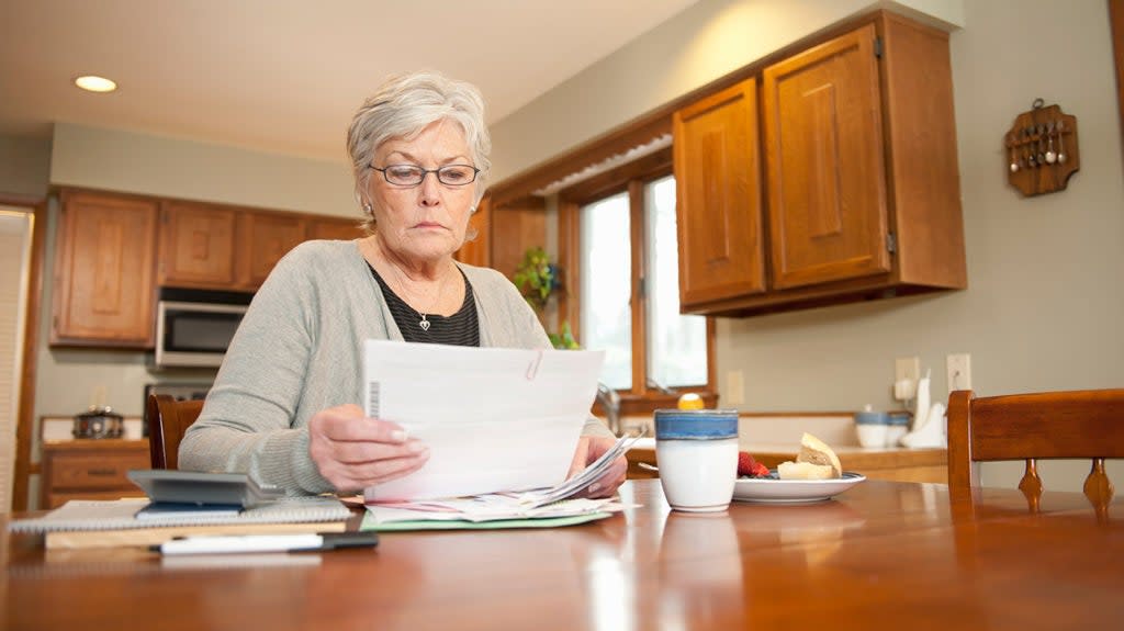 a woman looking at some bills for medicare part a to see how much it costs