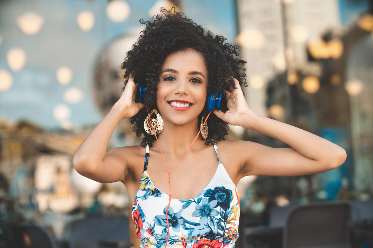 curly haired woman with headphones