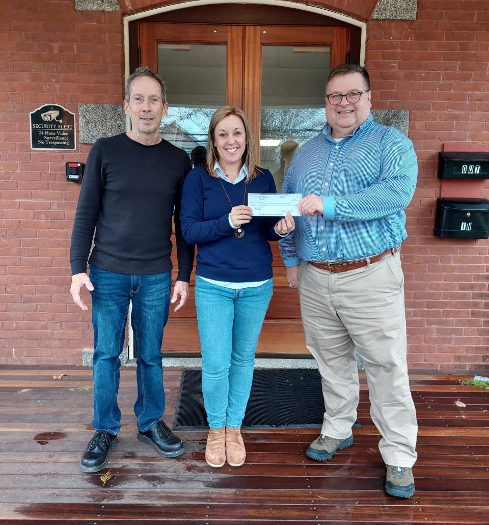 The Rev. Jeff Hunt and music director Stephen MacKenzie, of St. John’s United Methodist Church, present a check to Melissa Larocque, ddirector of operations for Dover Children’s Home.