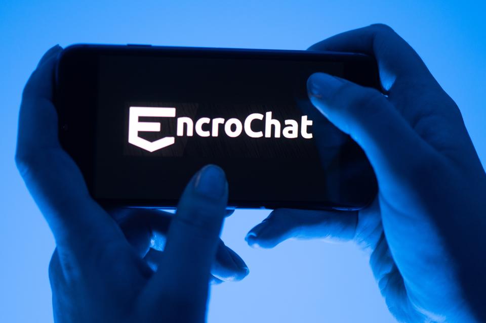 12 May 2022, Saxony, Dresden: ILLUSTRATION - A woman holds a smartphone with the logo of the crypto-messenger service Encrochat (posed scene). Photo: Sebastian Kahnert/dpa (Photo by Sebastian Kahnert/picture alliance via Getty Images)