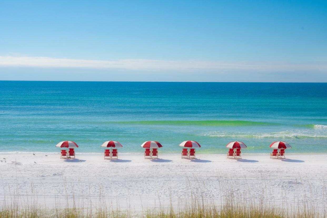 Colorful Row of Red Chairs on the Beach