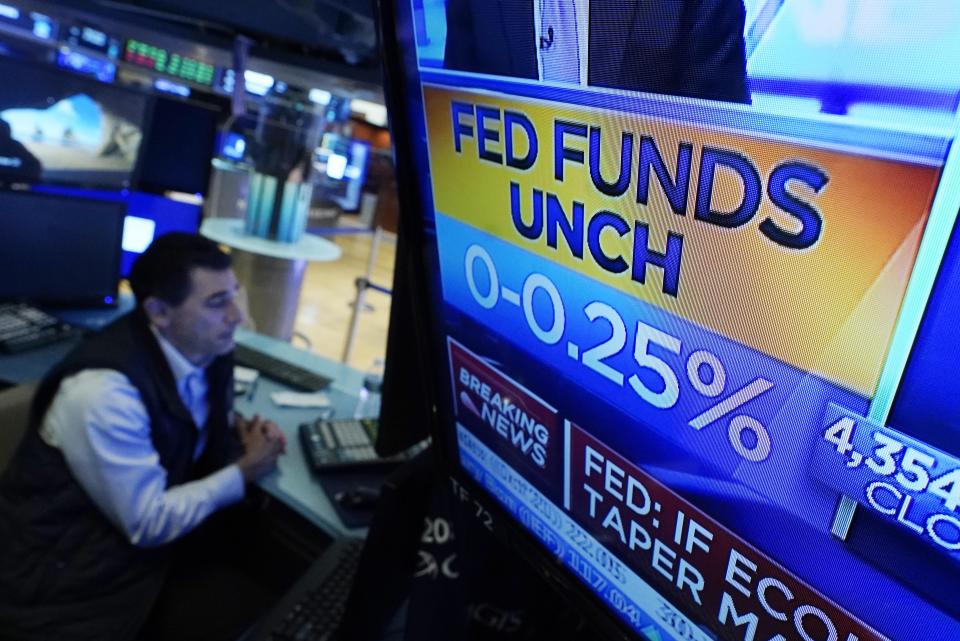 A screen on the floor of the New York Stock Exchange shows the rate decision of the Federal Reserve, Wednesday, Sept. 22, 2021. The Federal Reserve signaled Wednesday that it may start raising its benchmark interest rate sometime next year, earlier than it envisioned three months ago and a sign that it's concerned that high inflation pressures may persist. (AP Photo/Richard Drew)