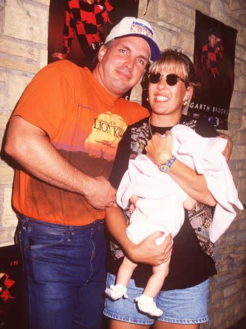 <p>Tammie Arroyo/Getty</p> Garth Brooks and Sandy Mahl with their daughter August in July 1994.