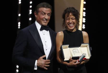 72nd Cannes Film Festival - Closing ceremony - Cannes, France, May 25, 2019. Director Mati Diop, Grand Prix award winner for her film "Atlantics" (Atlantique), reacts with Sylvester Stallone. REUTERS/Eric Gaillard